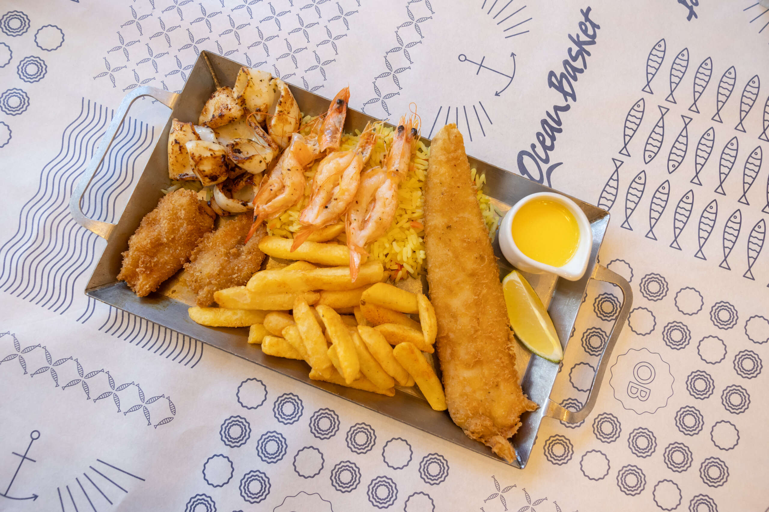 The Reel Love Platter is available for just R145 (including bread and complementaries, excluding wine or extras), and can be enjoyed for sit-down or takeaway at all Ocean Basket restaurants nationwide. It's the kind of thoughtful, tasty gesture that doesn't need gift wrap.
Whether you're celebrating your mom, your aunt, your grandmother, or the friend who's raising tiny legends with one hand and packing lunches with the other, this is your shot to treat her. And with the Reel Love Platter available until the end of May, you've got no excuse not to.
No reservation needed, just show up and make her day. Remember to follow Ocean Basket on Instagram or Facebook to stay hooked on the latest specials.